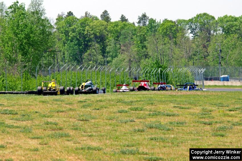 The formula car field streams out of turn six down to 7/8.