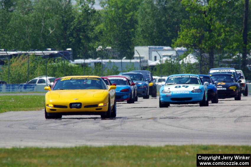 The Spec Miata and smaller production class field comes into turn 12 on the pace lap.