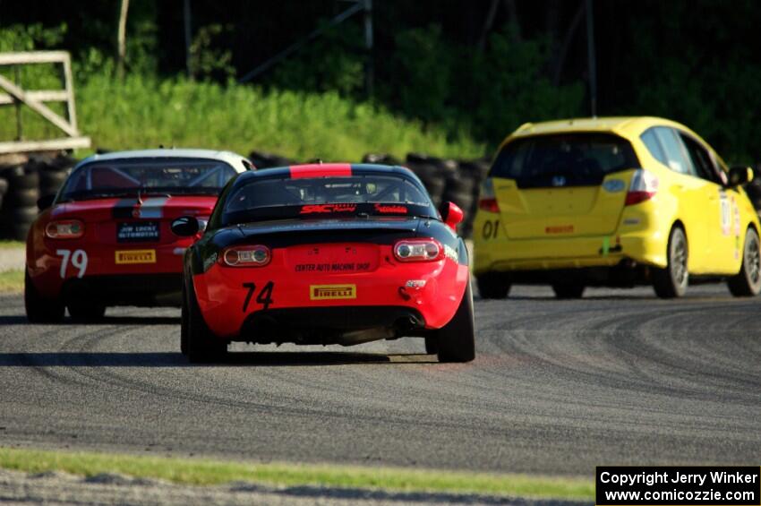 Spencer Patterson's and Matt Fassnacht's Mazda MX-5 Cups chase Jasper Drengler's Honda Fit