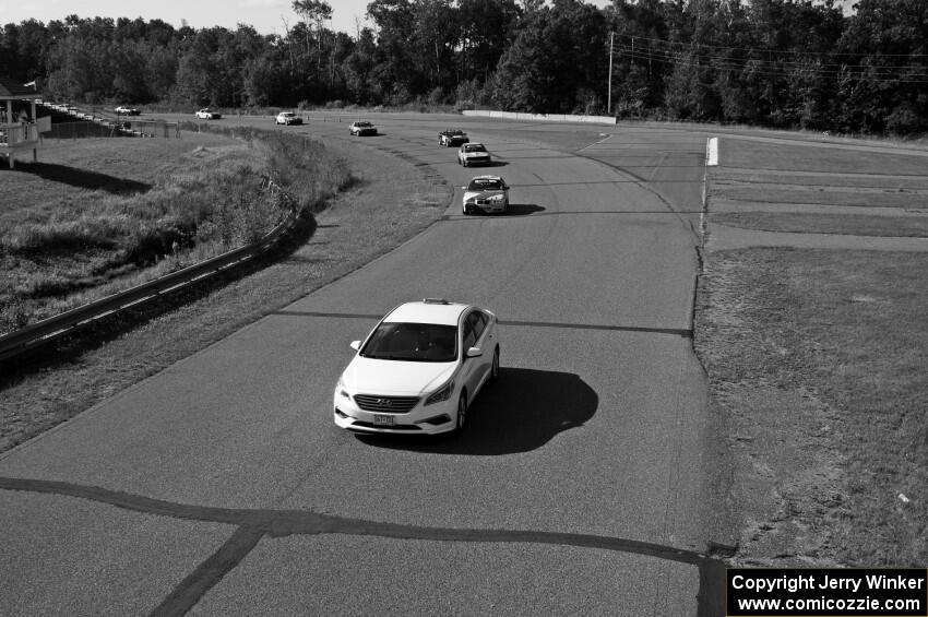 Behind the pace car at the start: Dirty Side Down Racing BMW 325i, Crank Yankers Racing BMW 325i, Just in Time Toyota MR2, etc.