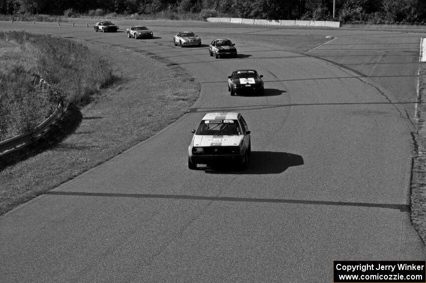 Six cars head through turn 9 before the bridge.