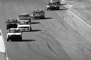 A group of cars streams between turns 5 and 6.