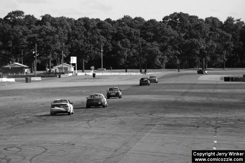 Six cars head down the Kinnard Straight and into tun 10.