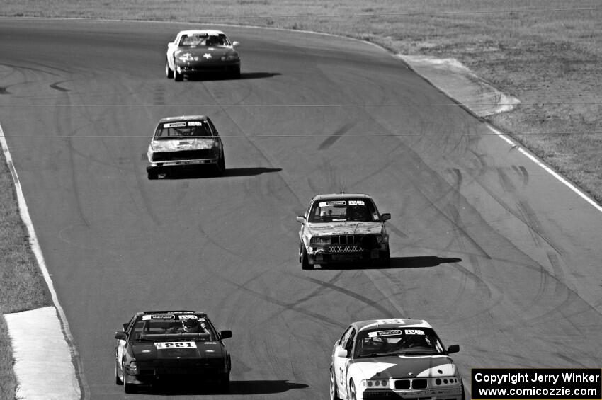 Five cars head out of turn 5 and into turn 6.