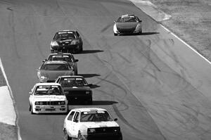 A group of cars streams between turns 5 and 6.