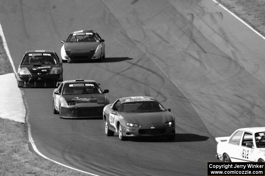 A group of cars heads into turn 6.