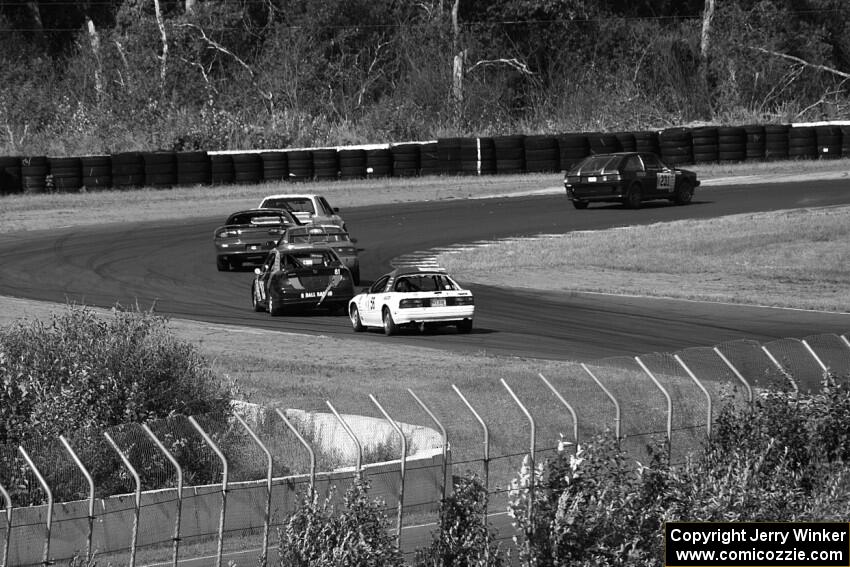 A group of cars heads through turns 7 and 8.