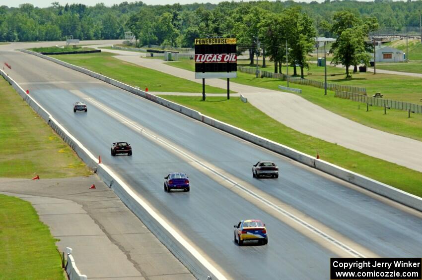 Five cars head down the front straight.