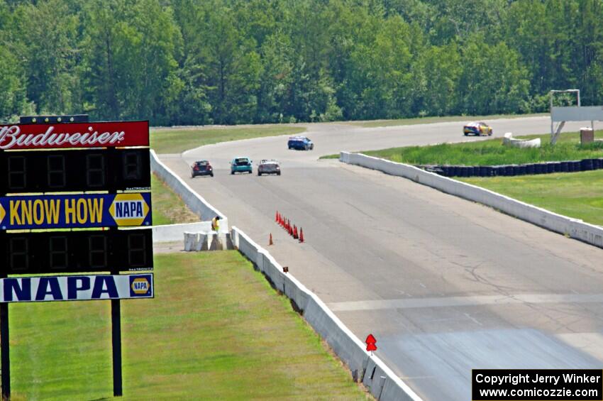 Five cars head down the front straight and into turn one.