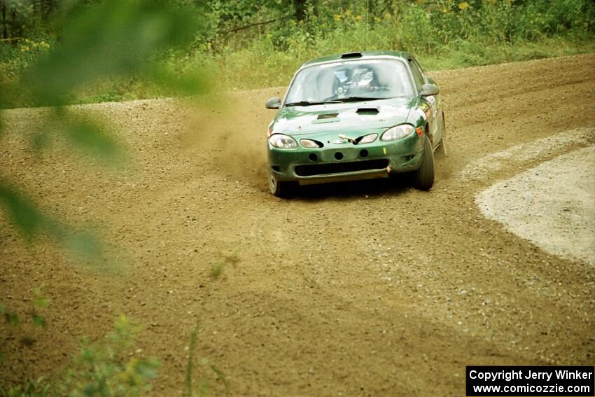 Tad Ohtake / Martin Dapot Ford Escort ZX2 at the spectator point on SS9 (The Spurs).