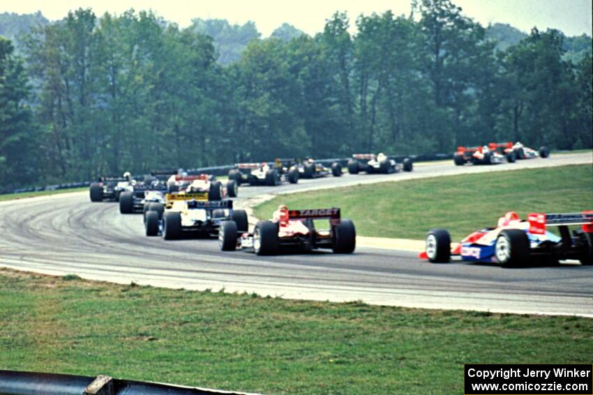 The front half of the field comes through turn one on the first lap.