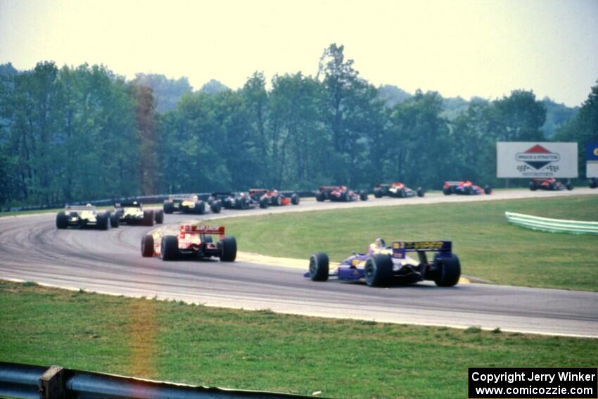 The back half of the field comes through turn one on the first lap.