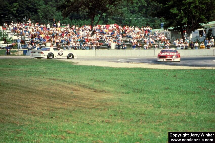 Bill Gray's Chevy Camaro spins, Walter Payton's Ford Mustang passes by.