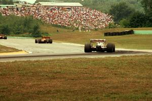 Nigel Mansell's Lola T-93/06/Ford Cosworth XB chases two cars out of turn 6.