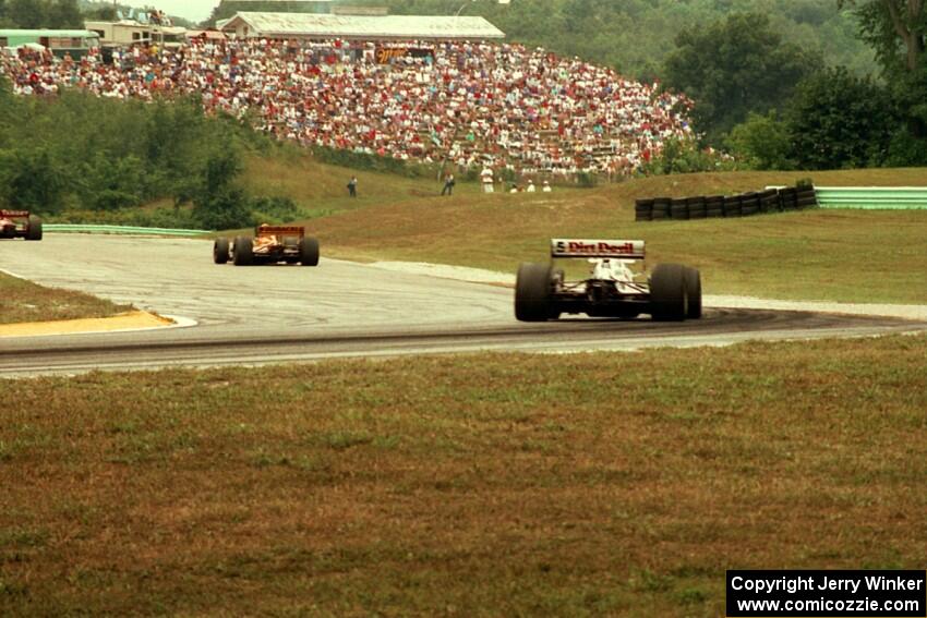 Nigel Mansell's Lola T-93/06/Ford Cosworth XB chases two cars out of turn 6.