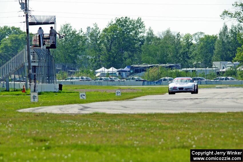 Bill Collins' T1 Chevy Corvette takes the checkered flag.