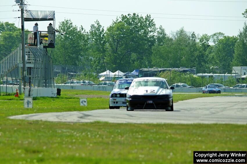 Tom Fuehrer's ITE-1 Ford Mustang and Mike Campbell's ITA BMW 325is take the checkered flag.