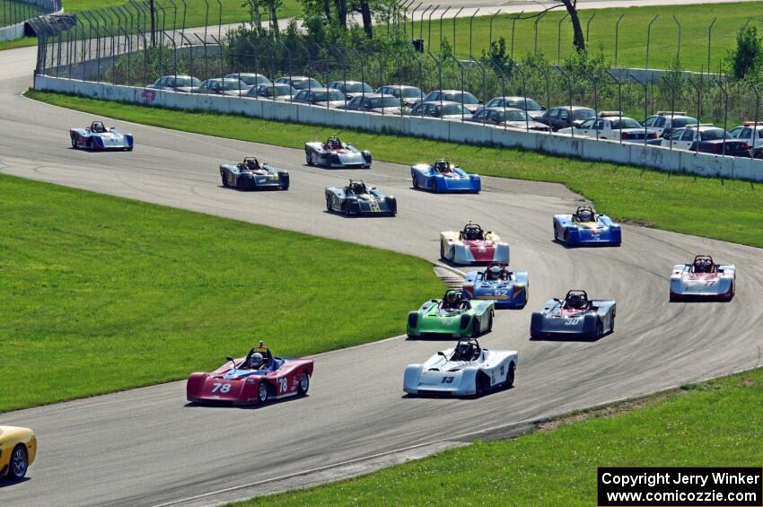 The field streams through turns 10 and 11 on the pace lap.