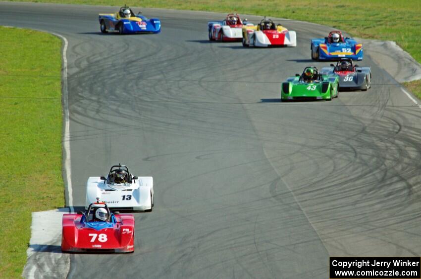 The field streams through turns 5 and 6 on the first lap.