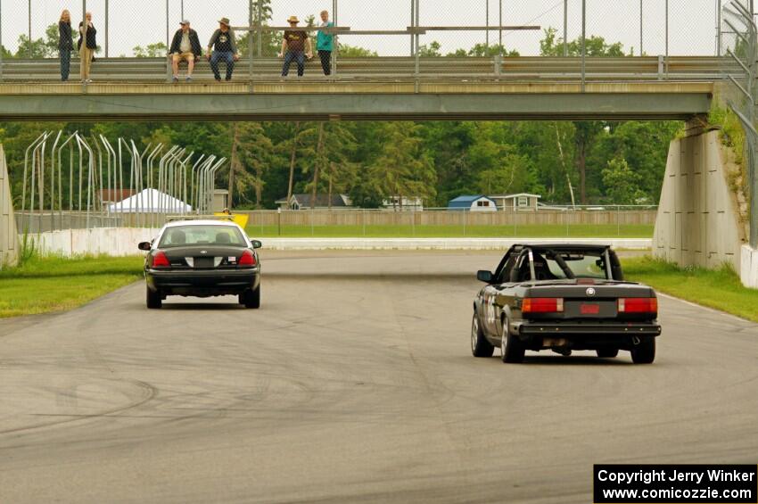 Jessica Johnk's ITJ BMW 325i follows the pace car.