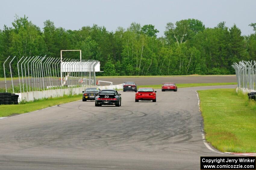 Five cars blast down the front straight into turn 1.