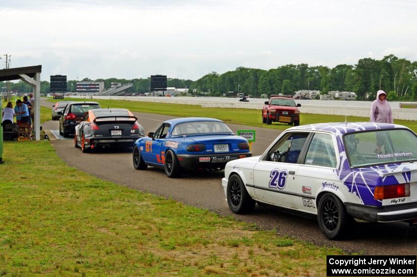 Cars line up at the scales after the race.