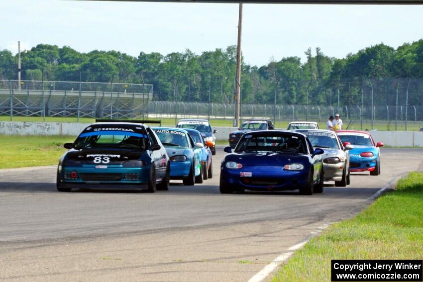 Mark Utecht's STL Honda Civic and Samantha Silver's Spec Miata Mazda Miata on the front row of the small production field.