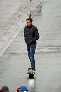 A spectator on a Onewheel electric skateboard.