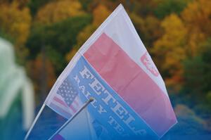 A spectator flies the Fetela Rally Team flag on SS15, Lakeshore Drive.