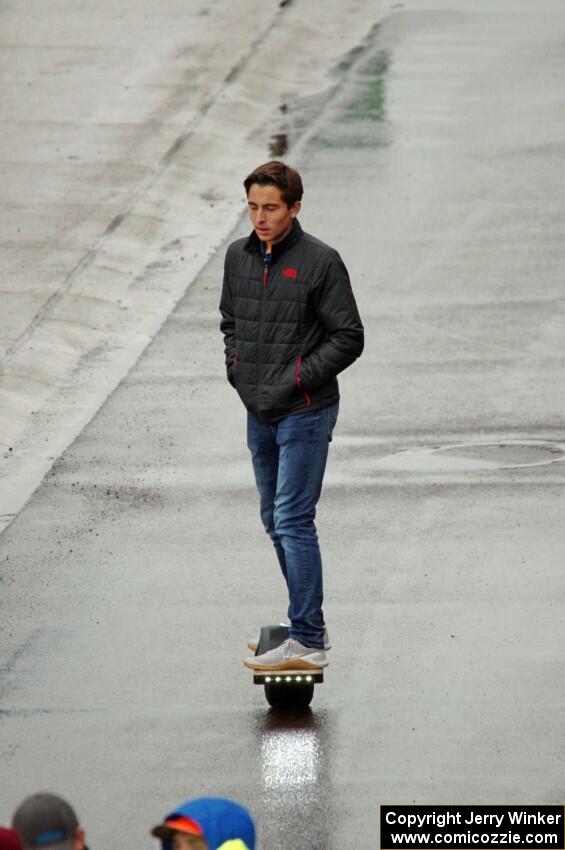 A spectator on a Onewheel electric skateboard.