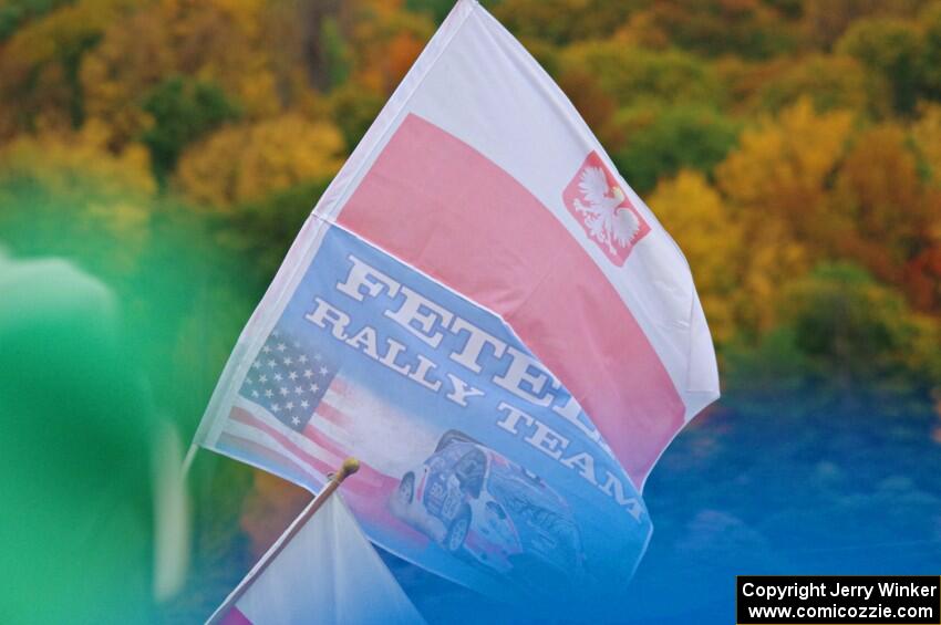 A spectator flies the Fetela Rally Team flag on SS15, Lakeshore Drive.