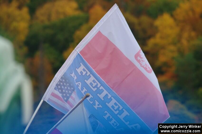 A spectator flies the Fetela Rally Team flag on SS15, Lakeshore Drive.