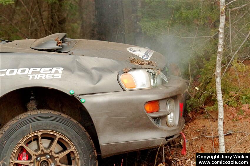 Jordan Locher / Tom Addison Subaru Impreza 2.5RS up against a tree after rolling on SS1.