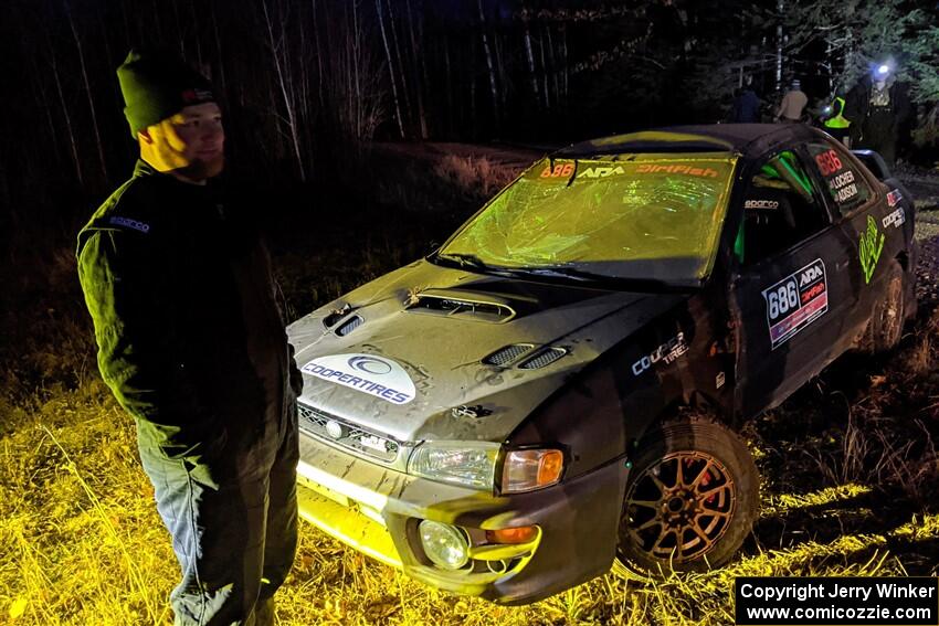 Jordan Locher / Tom Addison Subaru Impreza 2.5RS is pulled from the woods after rolling on SS1.