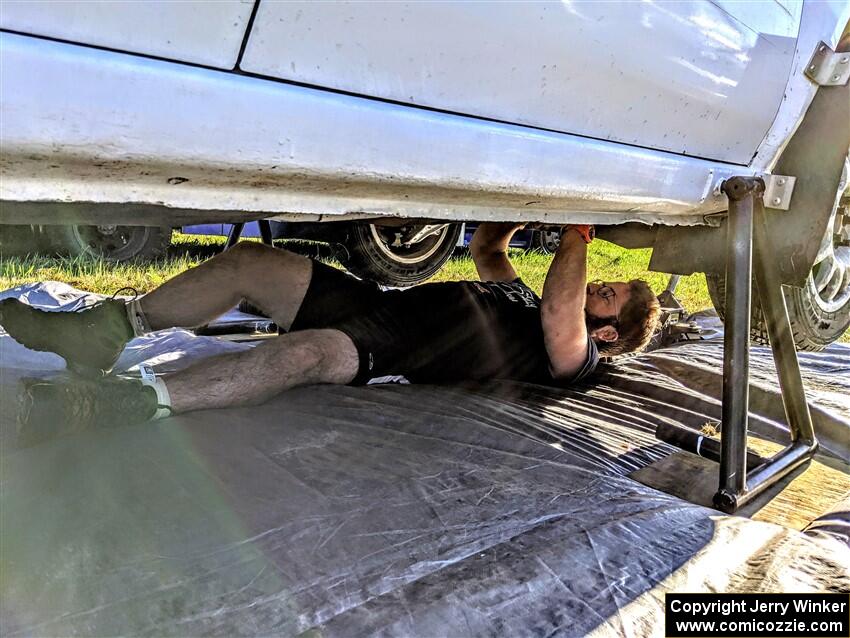 Kevin Dobrowolski underneath the team's Subaru Impreza 2.5i prior to the start of day two.