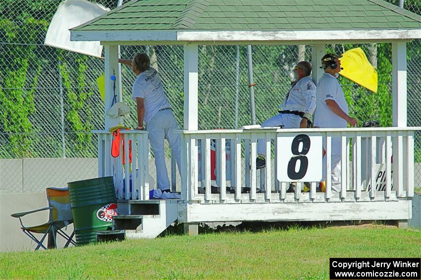 Corner workers at turn 8 notify race traffic of Dave Schaal's stuck car.