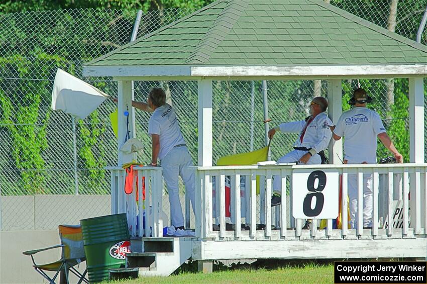 Corner workers at turn 8 notify race traffic of Dave Schaal's stuck car.