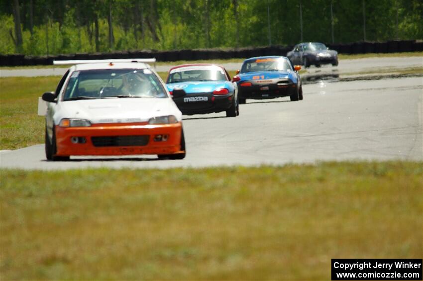 Ben Wedge's ITJ Honda Civic, Rick Buan's Spec Miata Mazda Miata and Gordon Kuhnley's Spec Miata Mazda Miata