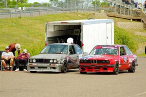 Brighten Hallberg's ITA BMW 328 and Mike Campbell's ITS BMW 325is in the paddock.