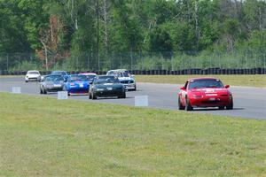 Andrew Jenkins' Mazda Miata leads a pack of cars.