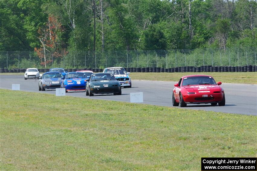 Andrew Jenkins' Mazda Miata leads a pack of cars.