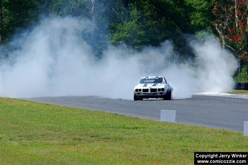 Scott Graham's Pontiac Firebird does a smokey burnout after looping it in turn three.