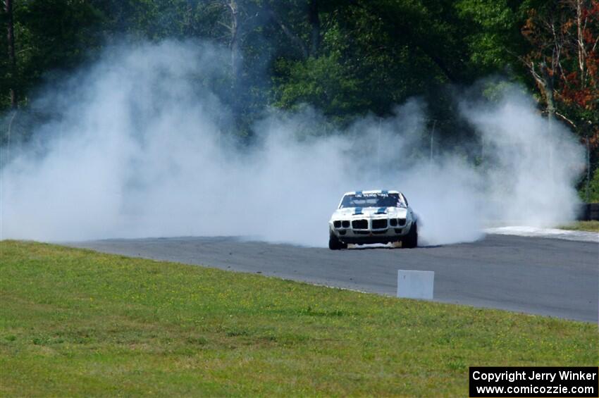 Scott Graham's Pontiac Firebird does a smokey burnout after looping it in turn three.