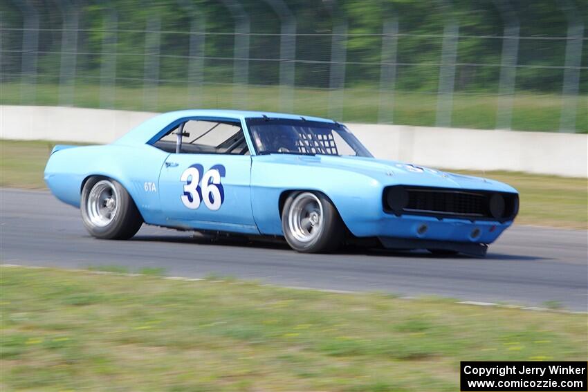 Scott Shadel's Chevy Camaro limps by with a broken suspension and flat tire.