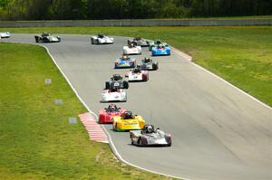 The Spec Racer Ford 3 field comes through turns 5 and 6 on lap one.