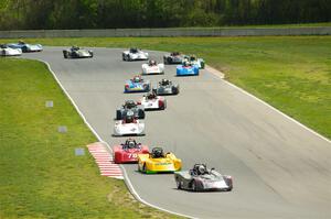 The Spec Racer Ford 3 field comes through turns 5 and 6 on lap one.