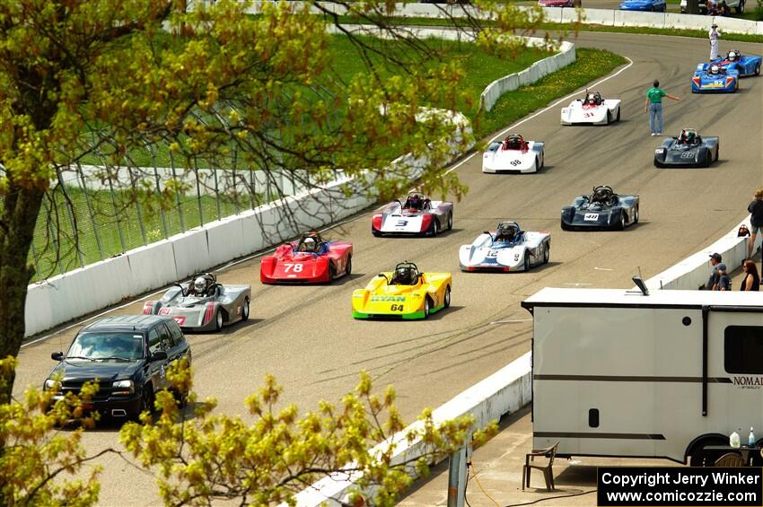 The Spec Racer Ford 3 field comes through pit lane to start the pace lap.