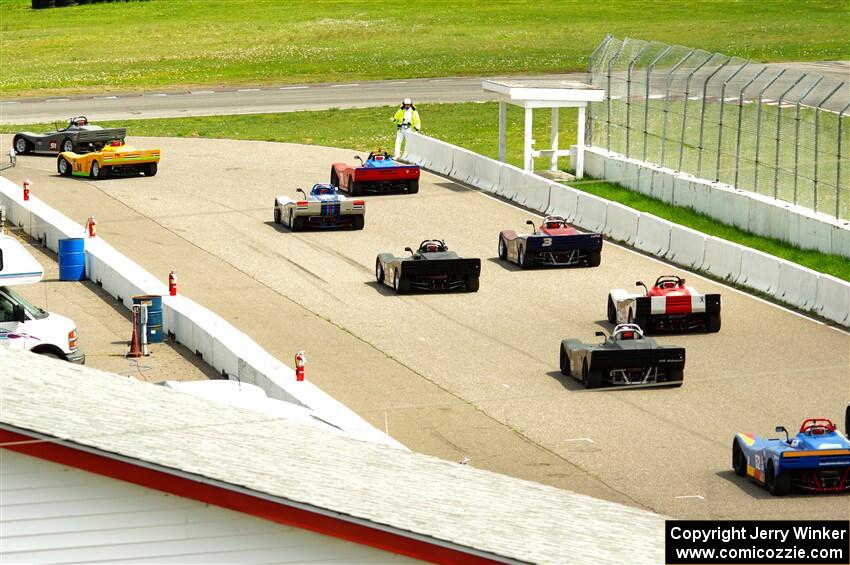 The Spec Racer Ford 3 field comes through pit lane to start the pace lap.