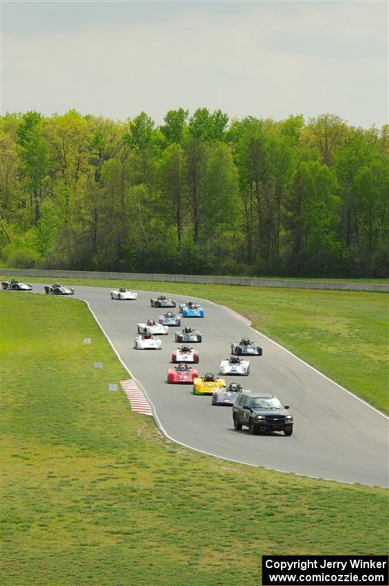 The Spec Racer Ford 3 field comes through turns 5 and 6 on the pace lap.