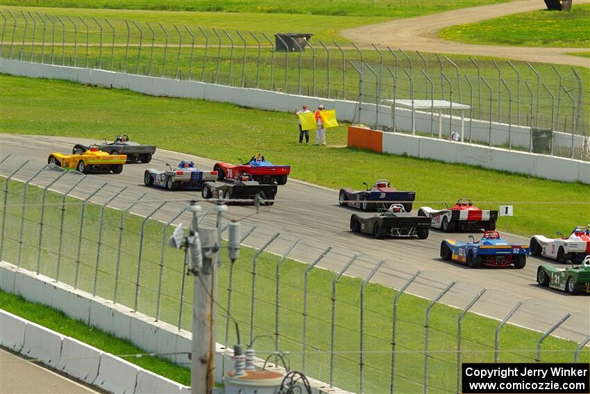 The Spec Racer Ford 3 field comes through turn 12 on the pace lap.